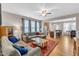 Open-concept living room with hardwood floors, ceiling fan and a view to the kitchen at 303 Leighann Ridge Ln, Rolesville, NC 27571