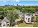 Aerial view of a modern home nestled among mature trees with the city skyline in the background at 304 S Tarboro St, Raleigh, NC 27610