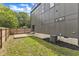 The modern home features a fenced yard, concrete patio, and exterior AC unit at 304 S Tarboro St, Raleigh, NC 27610