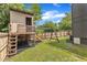Backyard featuring a wooden playset with a slide, a swing set, and a wooden fence surrounding the property at 304 S Tarboro St, Raleigh, NC 27610