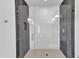 Modern glass shower featuring gray and white tiling, plus a rainfall shower head and hexagon-shaped floor at 304 S Tarboro St, Raleigh, NC 27610