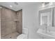 Bathroom with a modern vanity, square mirror, and a shower with neutral-toned brick-like tiles at 304 S Tarboro St, Raleigh, NC 27610