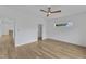 Bedroom featuring hardwood floors, white walls, modern fan, and a walk-in closet at 304 S Tarboro St, Raleigh, NC 27610