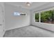 Minimalist bedroom with carpet, two large windows, and white walls at 304 S Tarboro St, Raleigh, NC 27610
