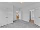 Spacious bedroom features neutral carpet, minimalist decor, and ample natural light from the doorways at 304 S Tarboro St, Raleigh, NC 27610