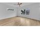 Bedroom featuring hardwood floors, a modern ceiling fan, and windows with neighborhood views at 304 S Tarboro St, Raleigh, NC 27610