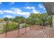 Spacious wood deck with metal cable railing offering neighborhood views under a bright blue sky filled with fluffy clouds at 304 S Tarboro St, Raleigh, NC 27610