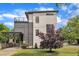 Modern two-story home featuring light siding, dark accents, a carport, and a rooftop patio at 304 S Tarboro St, Raleigh, NC 27610
