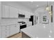 Bright kitchen features sleek white cabinets and stainless steel appliances at 304 S Tarboro St, Raleigh, NC 27610