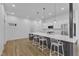Modern kitchen featuring a large island with seating, stainless appliances, and bright lighting at 304 S Tarboro St, Raleigh, NC 27610