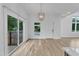 Bright living room with wood floors, modern lighting, and large windows with an outdoor view at 304 S Tarboro St, Raleigh, NC 27610