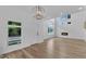 Bright living room features a modern fireplace, big windows and beautiful wood floors at 304 S Tarboro St, Raleigh, NC 27610