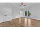 Spacious main bedroom with hardwood floors, white trim, and a ceiling fan, leading to a private outdoor deck at 304 S Tarboro St, Raleigh, NC 27610