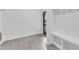 Clean mud room with gray tile floors, built-in bench, and hooks by the back door at 304 S Tarboro St, Raleigh, NC 27610