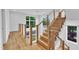 Modern staircase with natural wood steps, cable railings, and large windows at 304 S Tarboro St, Raleigh, NC 27610