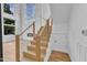 Modern staircase with wood steps and cable railings, and large windows bringing in natural light at 304 S Tarboro St, Raleigh, NC 27610