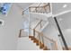 Modern staircase featuring wood stairs, cable railings, and windows throughout at 304 S Tarboro St, Raleigh, NC 27610