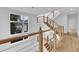 Bright staircase with wood railing and steps, cable railing, and big windows at 304 S Tarboro St, Raleigh, NC 27610