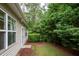 The property features a private backyard backing onto a tranquil wooded area at 306 Plank Bridge Way, Morrisville, NC 27560