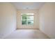 Sunny bedroom with neutral walls and carpet, and a large window overlooking the front yard at 306 Plank Bridge Way, Morrisville, NC 27560