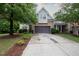 Home exterior featuring a two-car garage, landscaping and stone details at 306 Plank Bridge Way, Morrisville, NC 27560