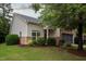 Exterior angle showcasing siding, stone accents, landscaping and attached garage at 306 Plank Bridge Way, Morrisville, NC 27560