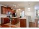 Well-equipped kitchen features wooden cabinets, stainless steel appliances, and a kitchen island with additional storage at 306 Plank Bridge Way, Morrisville, NC 27560