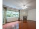 Inviting living room features a fireplace, large windows with natural light, and beautiful hardwood flooring at 306 Plank Bridge Way, Morrisville, NC 27560