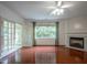 Bright living room with fireplace, hardwood floors, and glass doors leading to a patio at 306 Plank Bridge Way, Morrisville, NC 27560