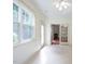 A bright sunroom with backyard access and glass doors that lead to a fireplace at 306 Plank Bridge Way, Morrisville, NC 27560