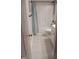 Well-lit bathroom with vanity and framed mirror, featuring a shower with a striped blue curtain at 31 Kevior Ave, Four Oaks, NC 27524