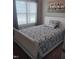 Cozy bedroom features a queen-sized bed with a patterned comforter and soft, natural light at 31 Kevior Ave, Four Oaks, NC 27524
