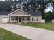 Charming single-story home with a well-manicured lawn and inviting front porch and long concrete driveway at 31 Kevior Ave, Four Oaks, NC 27524