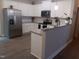 Bright kitchen featuring white cabinets, granite countertops, stainless steel appliances, and wood flooring at 31 Kevior Ave, Four Oaks, NC 27524