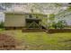 Spacious lawn backyard features a wood deck and tiered brick walls with wood privacy fencing at 318 Tillamook Dr, Wake Forest, NC 27587