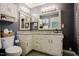 Modern bathroom featuring granite countertops, white cabinetry, and a large mirror at 318 Tillamook Dr, Wake Forest, NC 27587