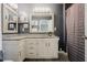 Well-lit bathroom features dual mirrors and a white vanity with granite countertop at 318 Tillamook Dr, Wake Forest, NC 27587