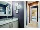 Modern bathroom features a white vanity with granite countertop, and contemporary lighting at 318 Tillamook Dr, Wake Forest, NC 27587