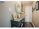Charming entryway with stylish blue console table, decorative mirror, and framed artwork at 318 Tillamook Dr, Wake Forest, NC 27587