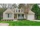 Charming home with beige siding, bay window, covered porch, and an attached one car garage at 318 Tillamook Dr, Wake Forest, NC 27587