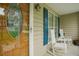 Inviting front porch featuring rocking chairs, blue shutters, and a decorative glass front door at 318 Tillamook Dr, Wake Forest, NC 27587