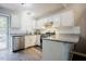 White kitchen featuring stainless steel appliances, light countertops and laminate flooring at 318 Tillamook Dr, Wake Forest, NC 27587