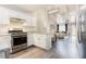 Bright kitchen flowing into the living room with high ceilings and a modern light fixture at 318 Tillamook Dr, Wake Forest, NC 27587