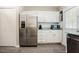 Bright kitchen featuring stainless steel appliances, white cabinetry and laminate flooring at 318 Tillamook Dr, Wake Forest, NC 27587