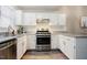 Clean white kitchen featuring stainless steel appliances and light countertops at 318 Tillamook Dr, Wake Forest, NC 27587