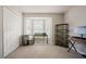 Office room with a big window, shelving, neutral colors, and carpet at 318 Tillamook Dr, Wake Forest, NC 27587