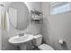 Modern powder room with a round mirror, stylish fixtures, and plenty of natural light at 320 Everly Mist Way, Wake Forest, NC 27587
