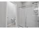 Modern shower with glass doors, and brushed nickel fixtures and a private toilet at 320 Everly Mist Way, Wake Forest, NC 27587