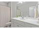Clean bathroom with a white vanity, neutral walls, and shower with curtain at 320 Everly Mist Way, Wake Forest, NC 27587