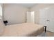 Cozy bedroom featuring carpeting, ample natural light, and a double-door closet at 320 Everly Mist Way, Wake Forest, NC 27587